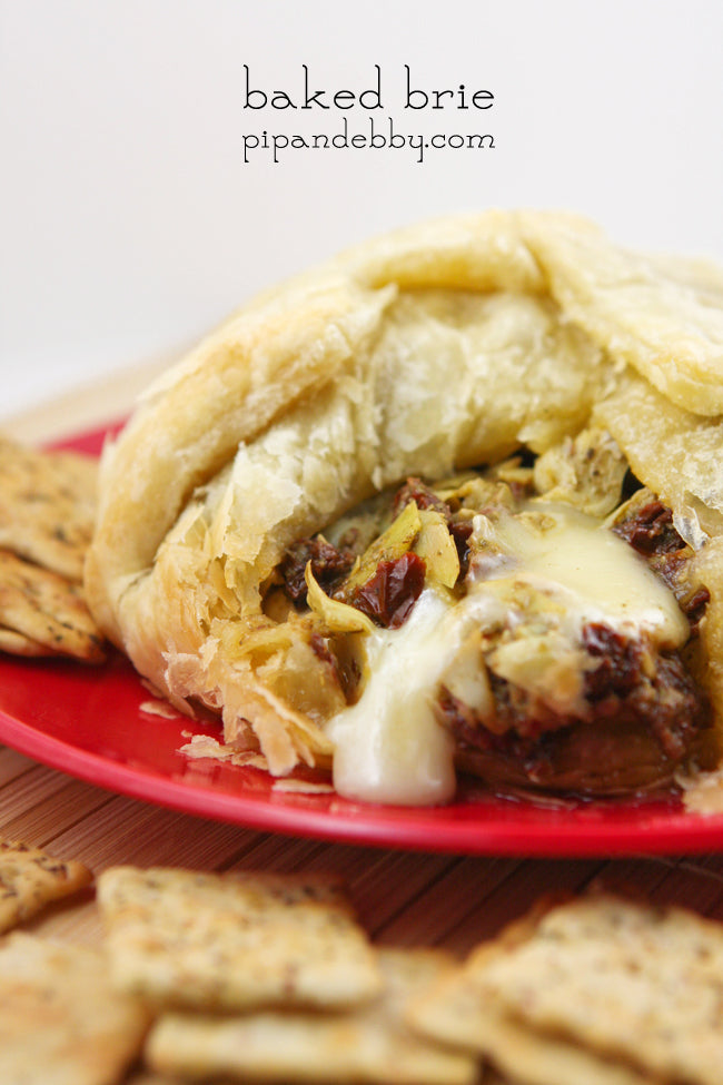 Baked Brie with Artichokes, Sun-dried Tomatoes and Pesto