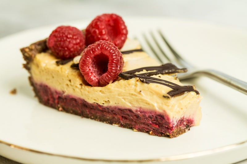 Chocolate Peanut Butter Fudge Tart with Raspberry Filling and White Chocolate Topping