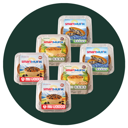 Six packaged smartMUFN chocolate chip cookie products in clear plastic clamshell containers, arranged in a fan-like cluster on a dark green circular background with a white outer field.