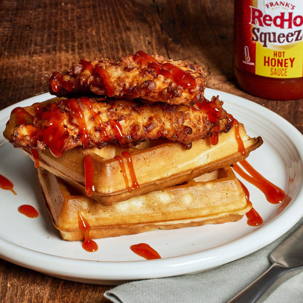 Fried chicken and waffles drizzled with Frank’s RedHot Squeeze Hot Honey Sauce
