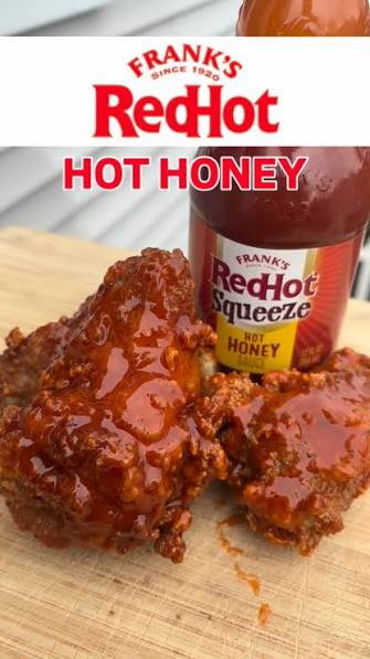 Sauce-coated chicken wings beside Frank’s RedHot Squeeze Hot Honey Sauce, with Hot Honey text above
