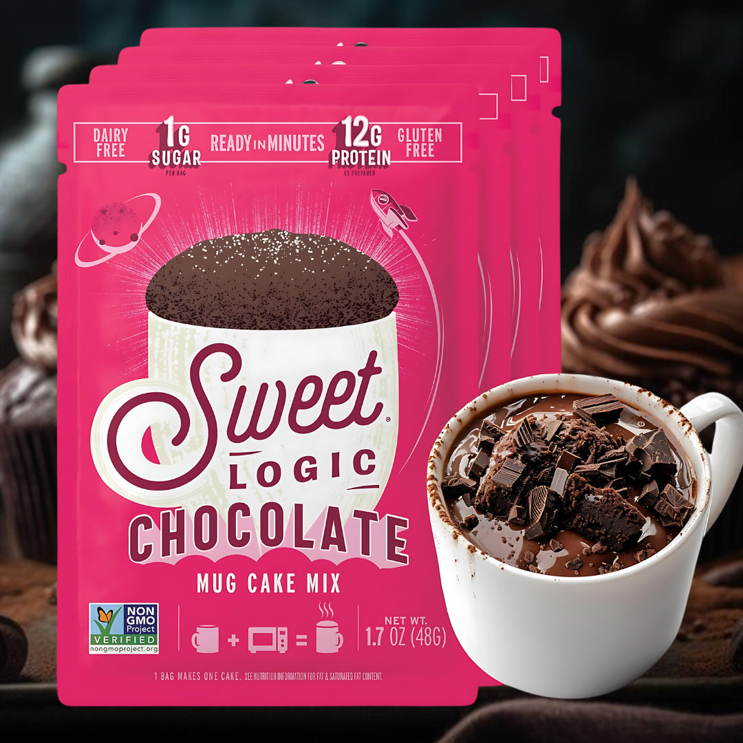 Pink package of Sweet Logic Chocolate Mug Cake Mix with a mug of hot chocolate in the background.