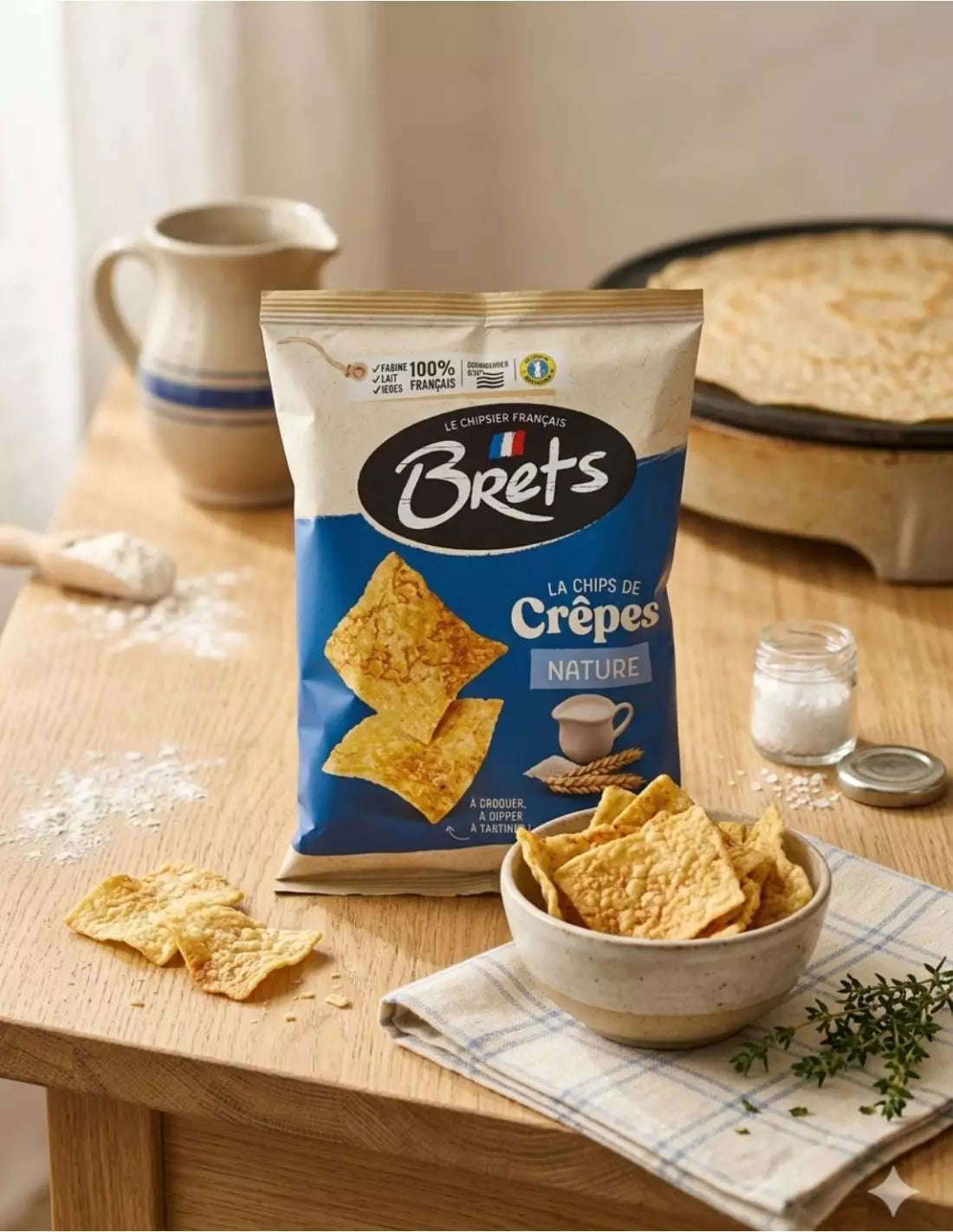 Brets Nature plain crêpe-chip bag beside a bowl of golden crisps on a wooden table

