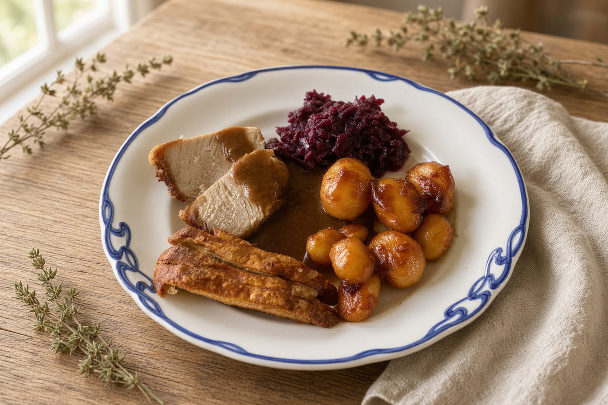 blue-rimmed pork plate: Danish holiday serving inspiration with roast pork, crackling, glazed potatoes, red cabbage, and gravy