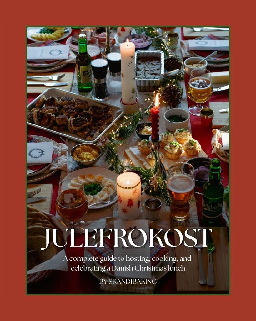 Skandibaking Julefrokost guide cover showing a candlelit Danish Christmas lunch table