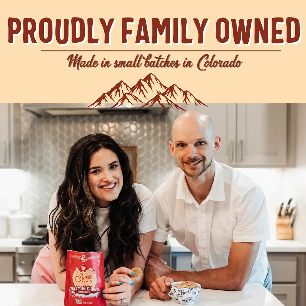 A man and a woman sitting at a kitchen table with a red bag of Sweet Logic Chocolate Chip Cookies in front of them. The top of the image features a beige banner with the text 'PROUDLY FAMILY OWNED' and 'Made in small batches in Colorado' above a brown mountain graphic.