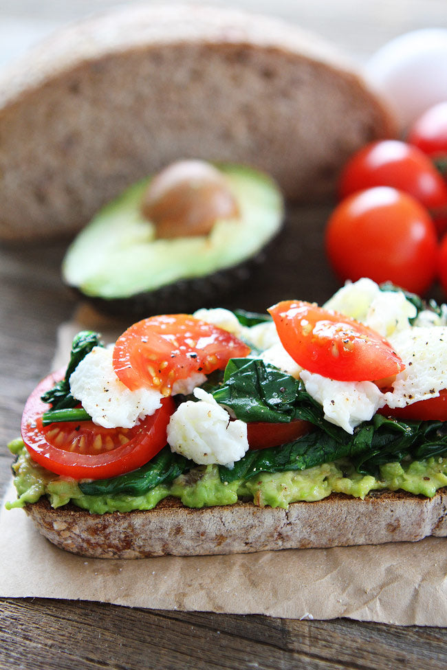 AVOCADO TOAST WITH EGGS, SPINACH, AND TOMATOES