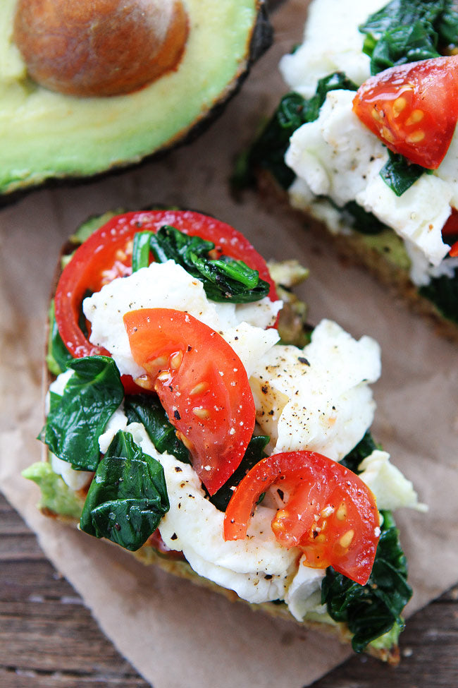 AVOCADO TOAST WITH EGGS, SPINACH, AND TOMATOES