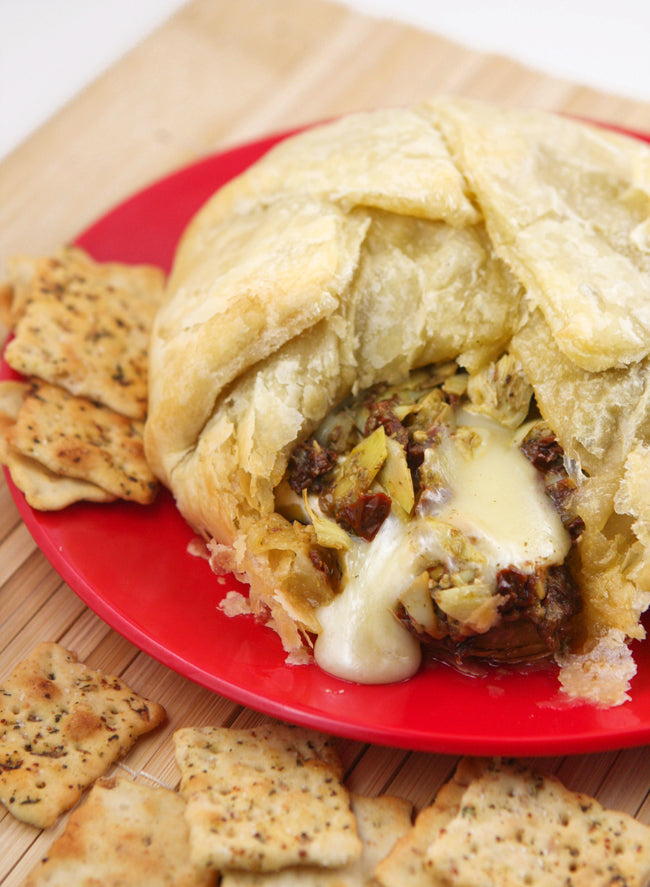 Baked Brie with Artichokes, Sun-dried Tomatoes and Pesto