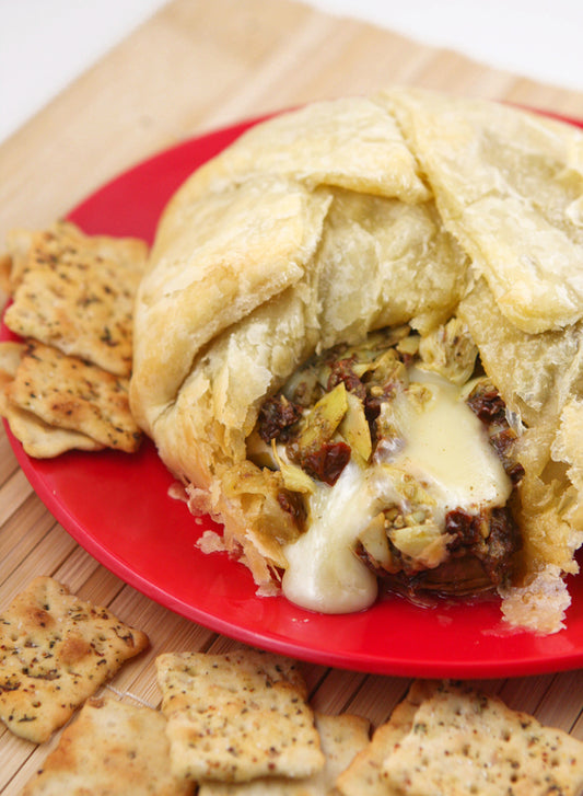 Baked Brie with Artichokes, Sun-dried Tomatoes and Pesto