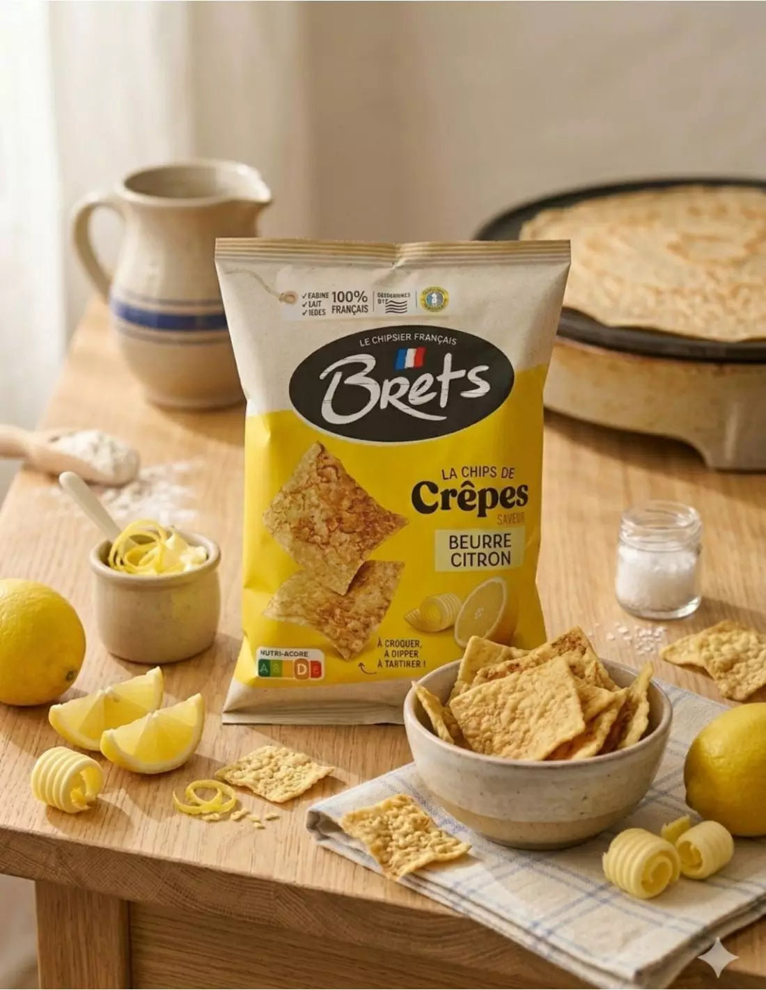 Brets Butter & Lemon crêpe chips with lemon wedges, butter curls and a bowl of golden crisps