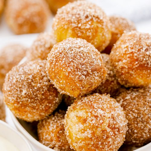 Sugar-coated pretzel bites piled in a white bowl.