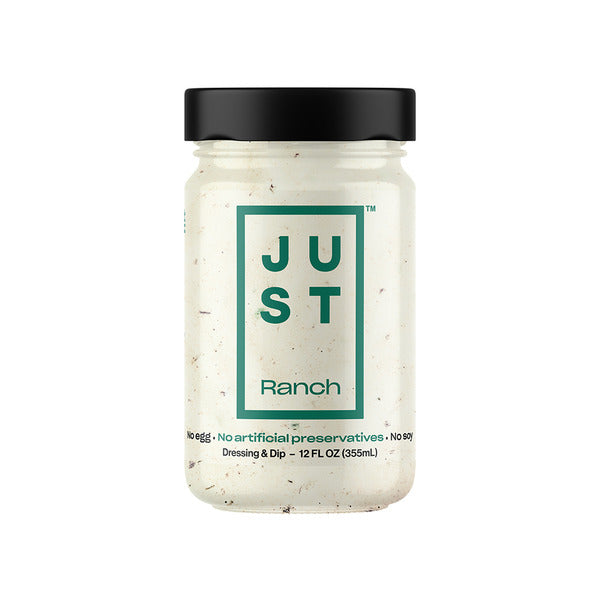 A glass jar of Just Ranch Dressing & Dip with a black lid and a white contents, featuring a green and black label on a solid white background.