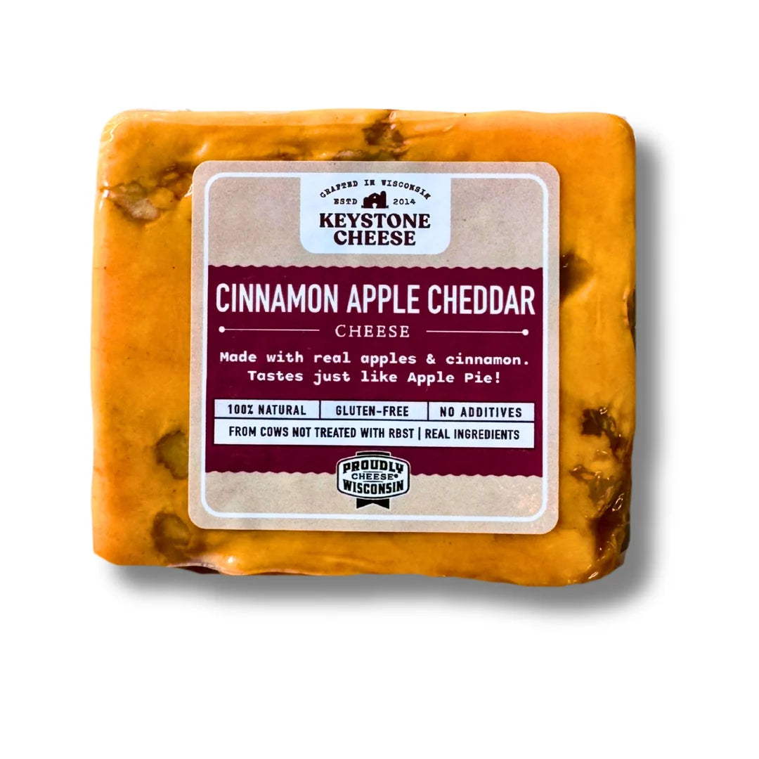 Block of Cinnamon Apple Cheddar cheese with Keystone Cheese label on a white background