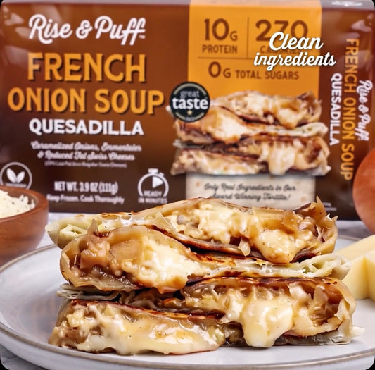 A close-up of a plated stack of cheesy French onion soup quesadillas in front of a Rise & Puff French Onion Soup Quesadilla box, with text reading 'Clean ingredients' on a white background.