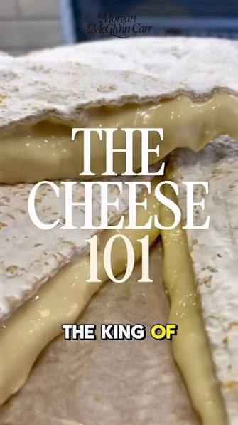 A close-up food photo of a cheesy baked tortilla wrap or quesadilla with melted yellow cheese oozing from a white tortilla, overlaid with large white text reading 'THE CHEESE 101' and smaller text 'THE KING OF'. A small script logo appears at the top.