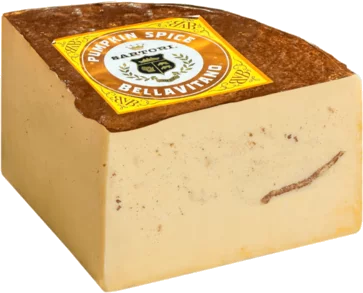 A wedge of Bellavitafo 'Pumpkin Spice' Harrot cheese, showing its creamy beige interior with a brown rind and a yellow label on top.