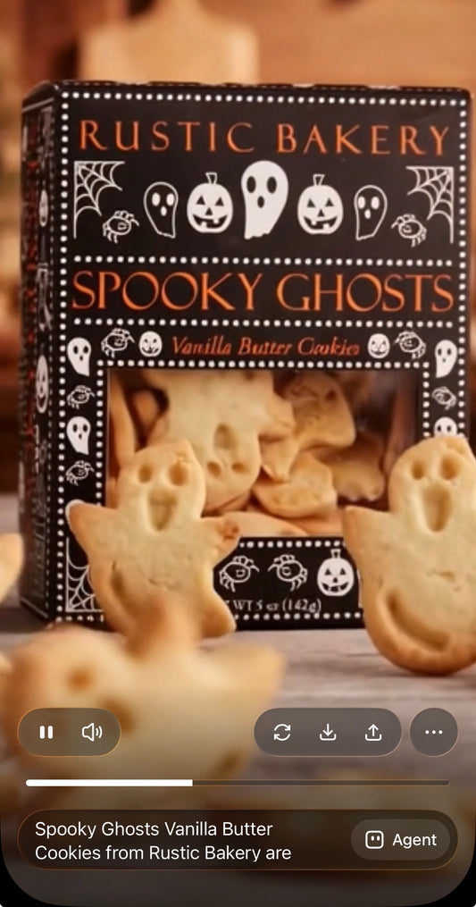 A box of Rustic Bakery Spooky Ghosts vanilla butter cookies displayed with several ghost-shaped cookies in front on a wooden surface.