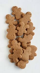 A pile of gingerbread man cookies on a plain white background.