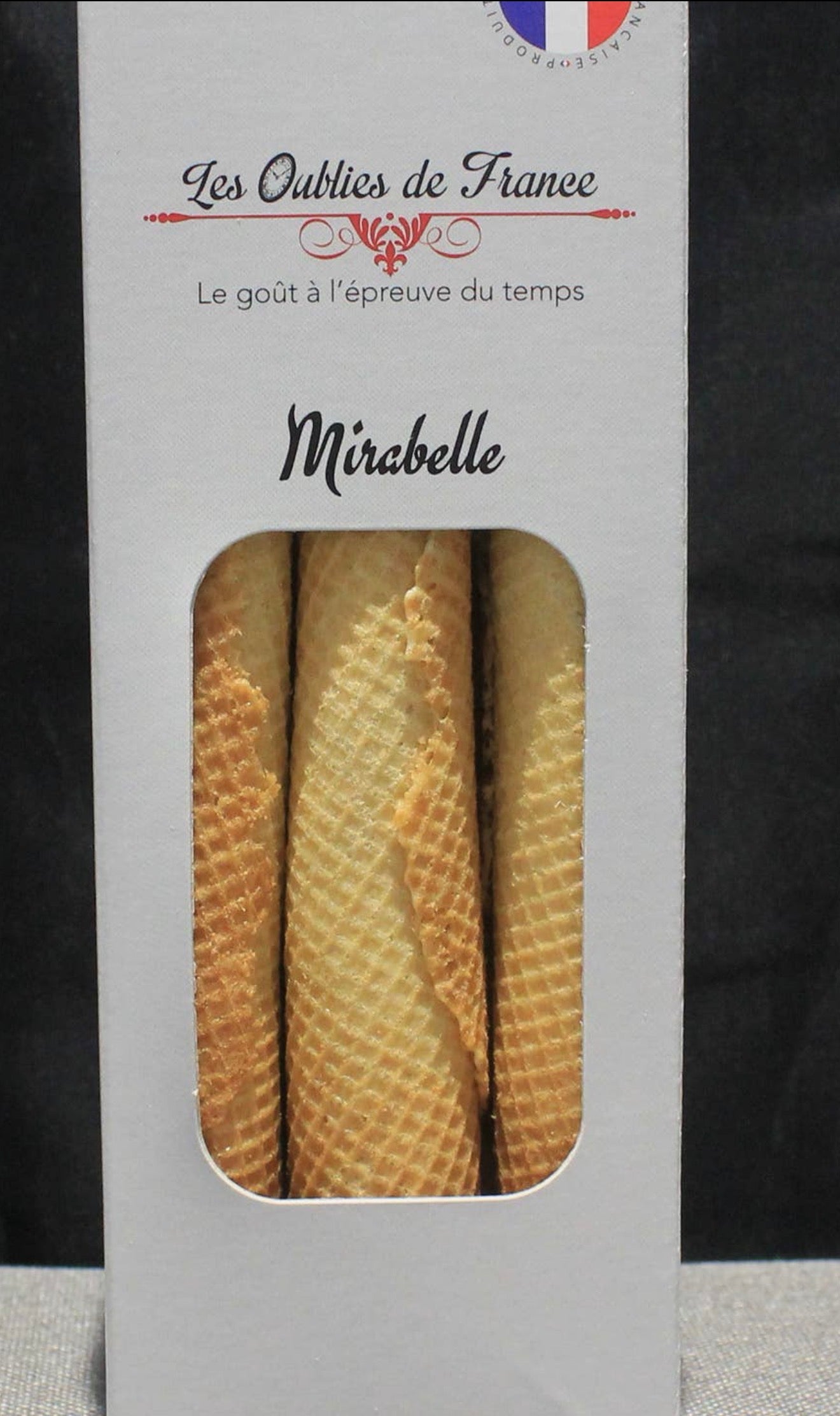 A boxed French pastry called Mirabelle from Les Oublies de France, showing three golden-brown waffle-cone pastries through a clear window on a white package.