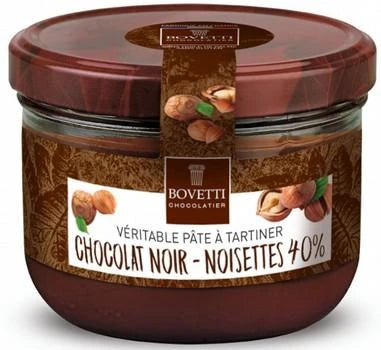 A glass jar of Bovetti Chocolatier chocolate with hazelnuts, featuring a dark brown lid and a brown and white label with hazelnut illustrations.