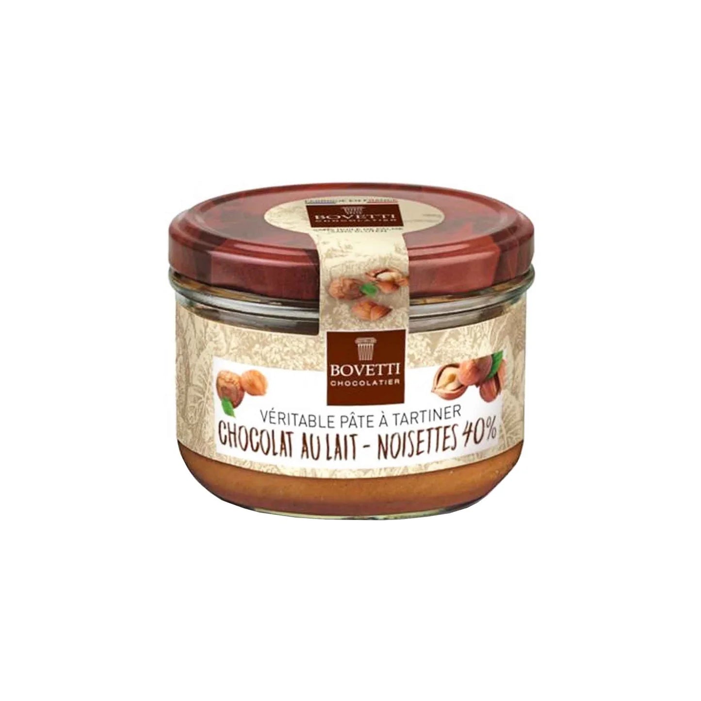A glass jar of Bovetti Chocolatier chocolate au lait with noisettes, featuring a cream-colored label and a dark red lid, set against a plain white background.