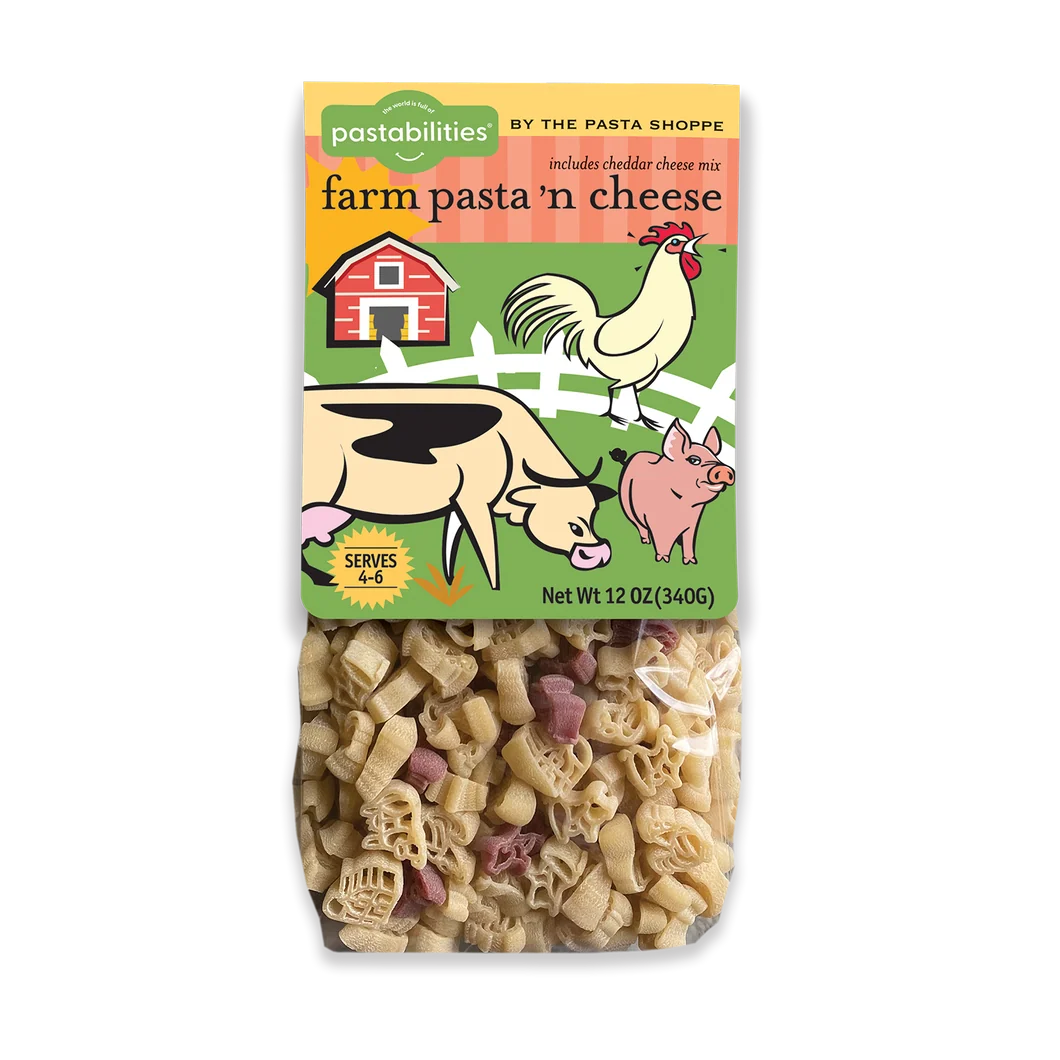 A package of Pastabilities Farm Pasta 'n Cheese, featuring a colorful cartoon label with a barn, rooster, cow, and pig above a clear window showing the mixed pasta inside.