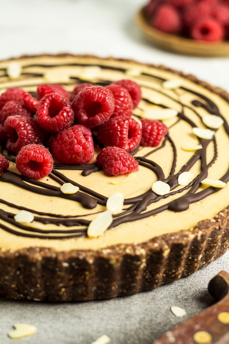 Chocolate Peanut Butter Fudge Tart with Raspberry Filling and White Chocolate Topping