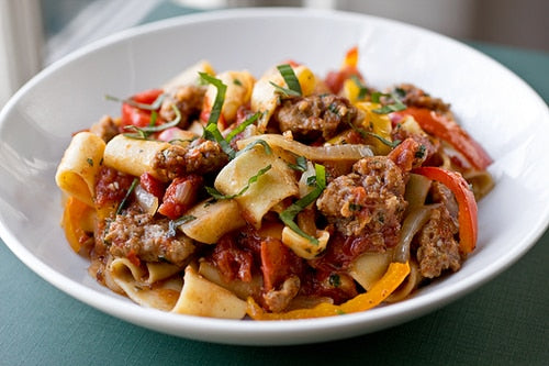 Saucy, Italian “Drunken” Noodles w/ Spicy Italian Sausage, Tomatoes, Caramelized Onions, Red & Yellow Bell Peppers, with Fresh Basil