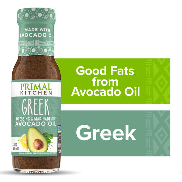 A bottle of Primal Kitchen Greek dressing and marinade with avocado oil, shown next to green informational text panels that read 'Good Fats from Avocado Oil' and 'Greek'.