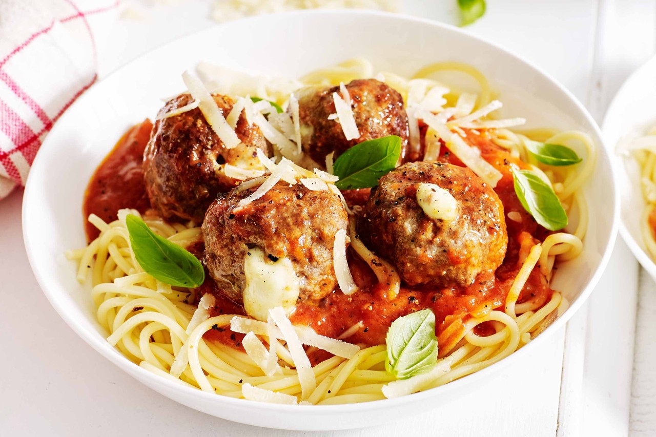 Cheesy Stuffed Meatballs over Spaghetti