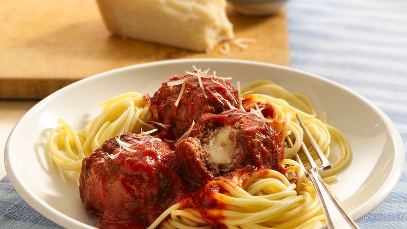 Cheesy Stuffed Meatballs over Spaghetti