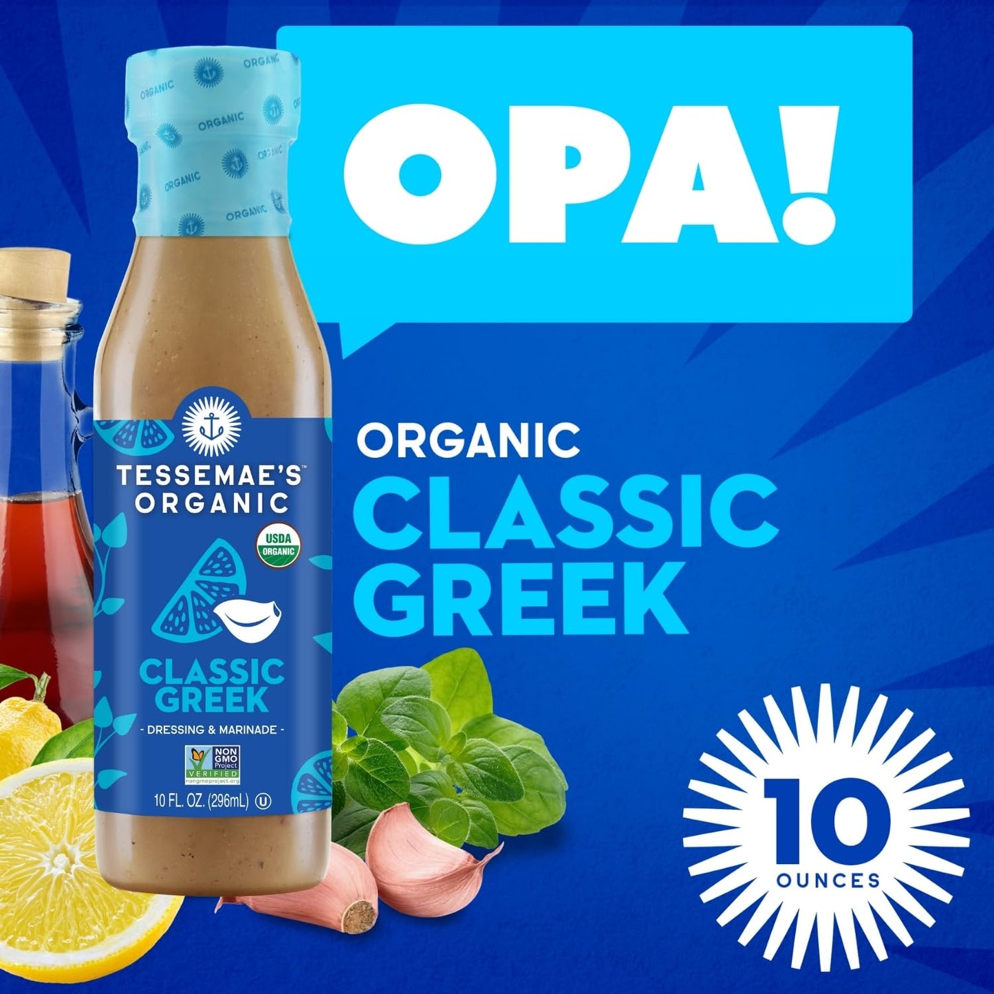 A bottle of Tessemae's Organic Classic Greek dressing on a blue promotional background with large white text reading 'OPA!' and 'ORGANIC CLASSIC GREEK,' plus a '10 OUNCES' badge and food illustrations.